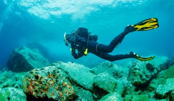 snorkler diving to shipwreck