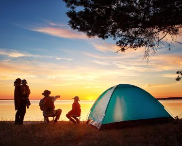 family spending time camping in state park