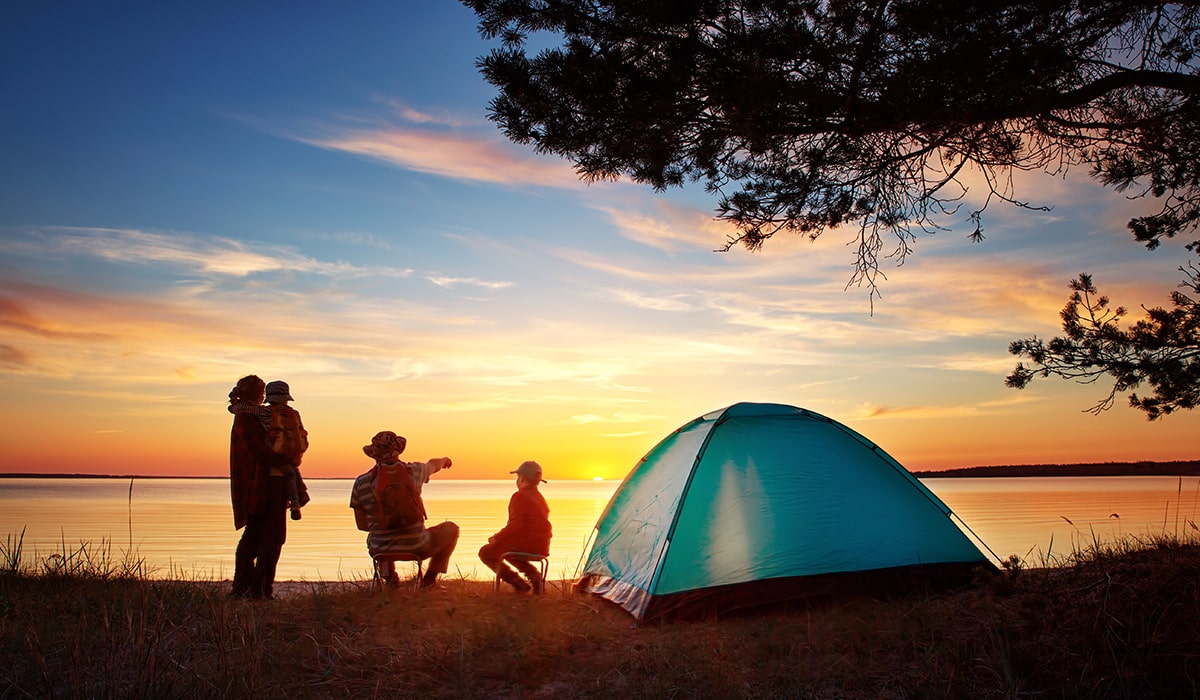 family spending time camping in state park