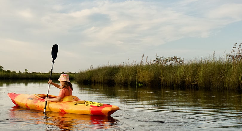 girl kayaking in state park river