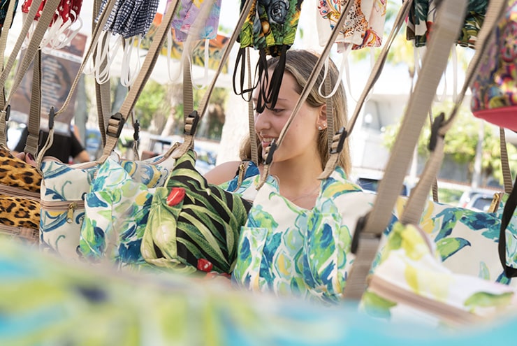 woman shopping at stall at market on main