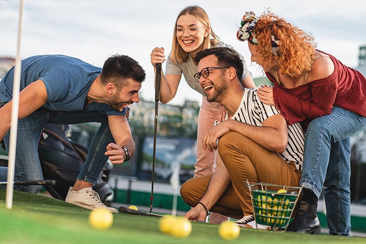 friends laughing at hole in martin county public course