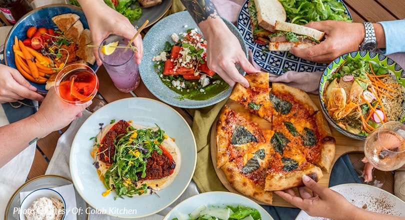 table full of plates of food at a martin county restaurant Colab Kitchen