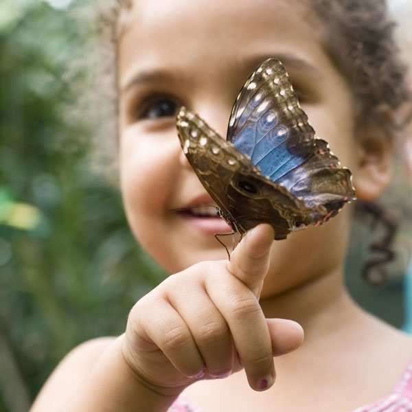 girl at OXBOW ECO-CENTER with butterfly