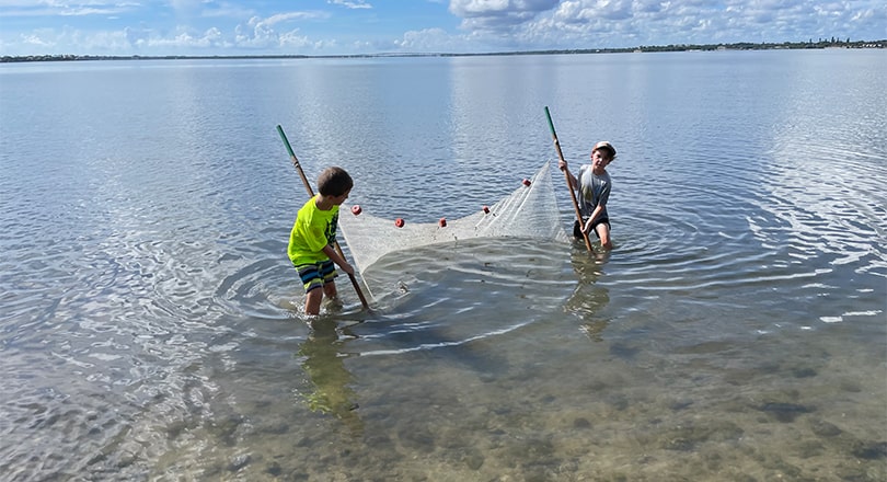 Martin County kids fishing with a net