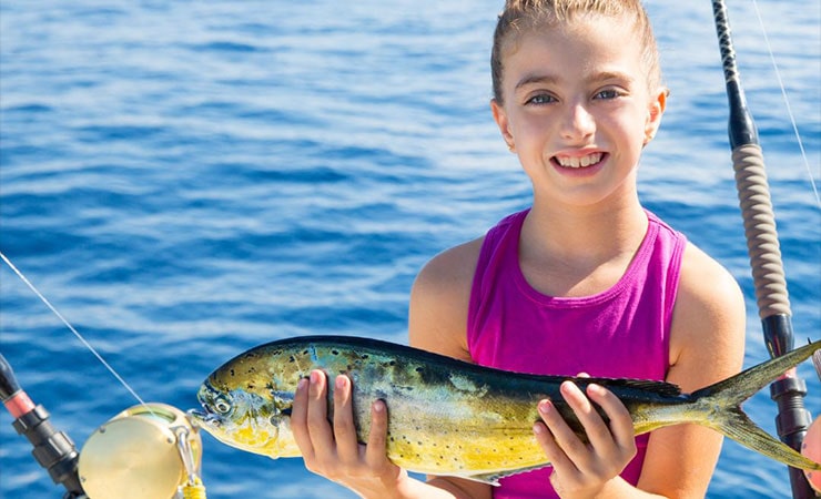 kid holding fish - events in Martin County