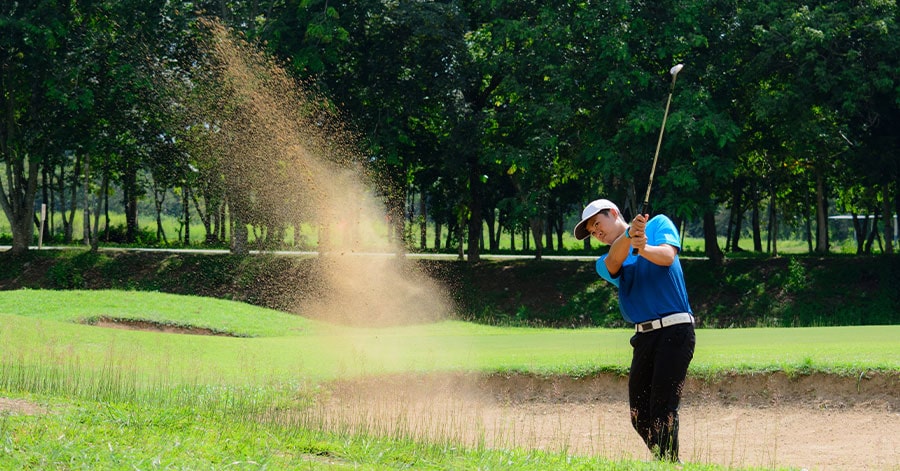 Man in sand trap at Jim Furyk Golf Course