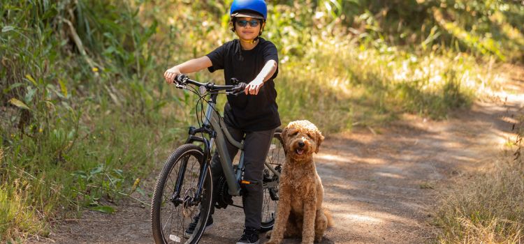 child riding bike with dog