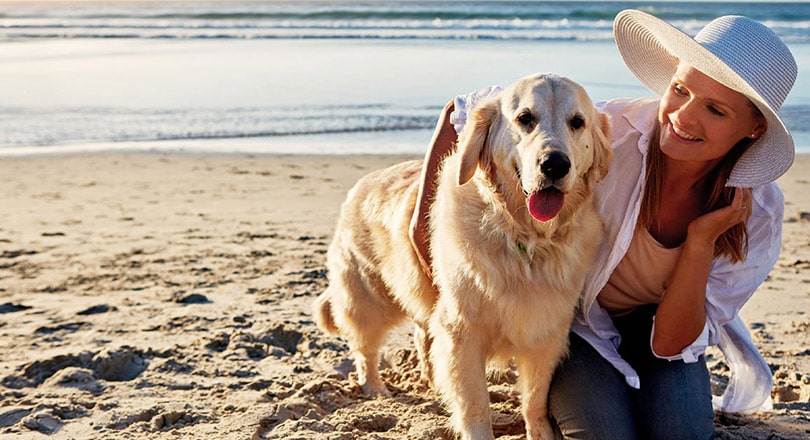 woman with dog on Satellite Beach