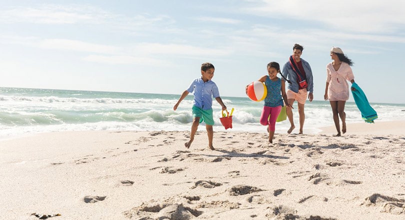 family playing on beach