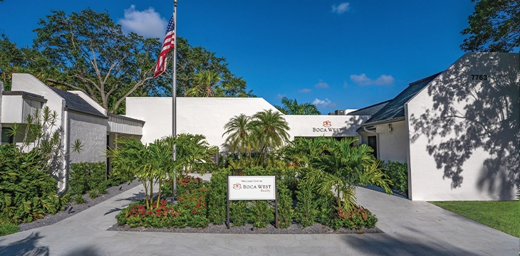 Boca West Realty welcome center entrance with landscaping