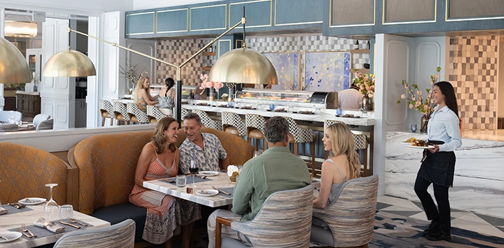 Members seated at a table enjoying dinner in a private club dining room