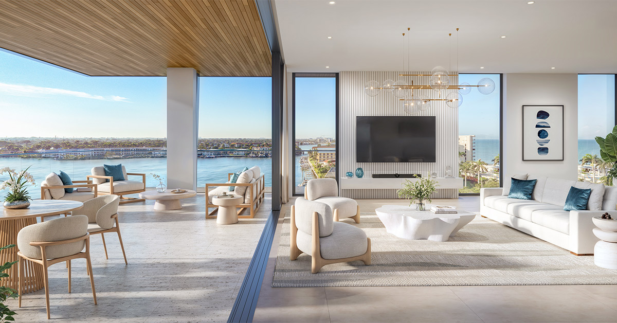 Luxury living room with terrace and large windows overlooking water and city.