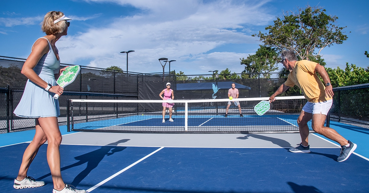 Residents playing pickleball on an outdoor court at Hideaway Beach Club on Marco Island.