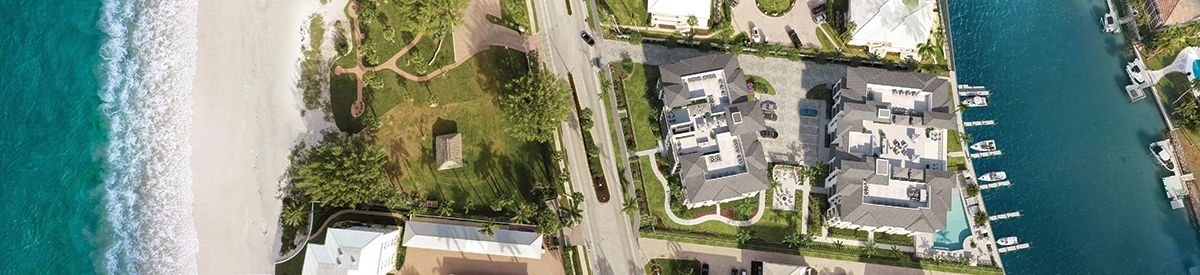 Aerial view of beachfront residences and marina in Naples