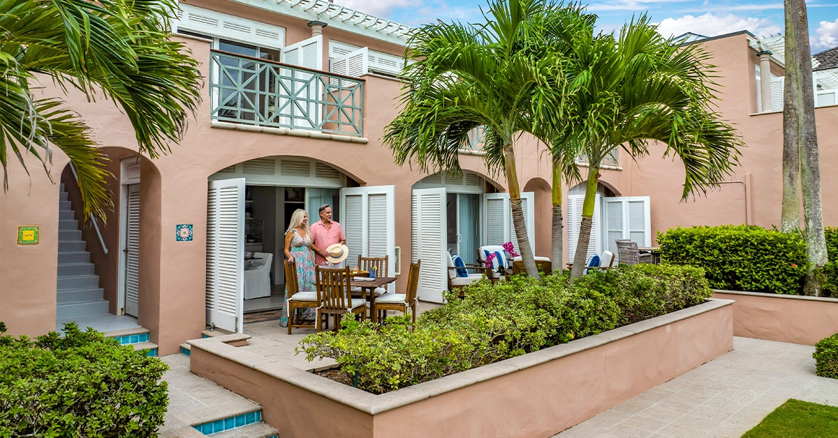 Couple standing outside a courtyard residence at Orchid Island private club community in Vero Beach