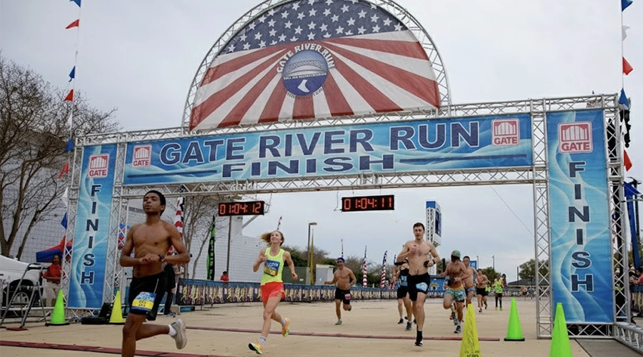 Runners crossing the finish line at the Gate River Run in Jacksonville