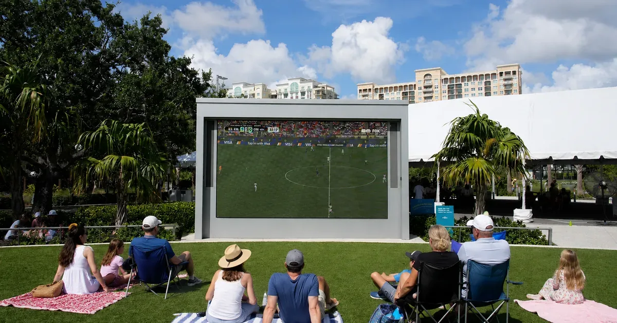 Family Watching World Cup Outside Theatre Sarasota Ai