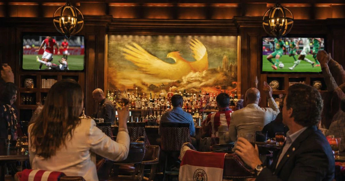 Guests watching an international soccer match inside an upscale Buckhead lounge.